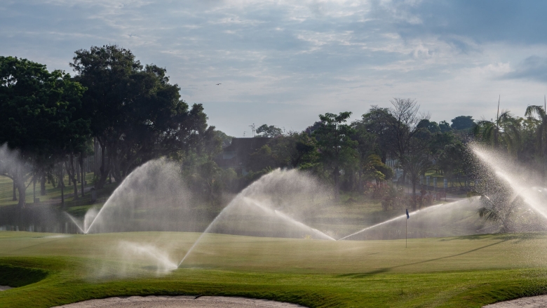 Sprinklers running on golf course.