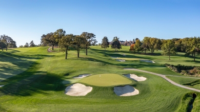 Ariel view of Omaha Country Club's green fairways with RTF bunker surrounds under blue skies.