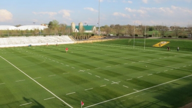 Photo of a grassy football field 
