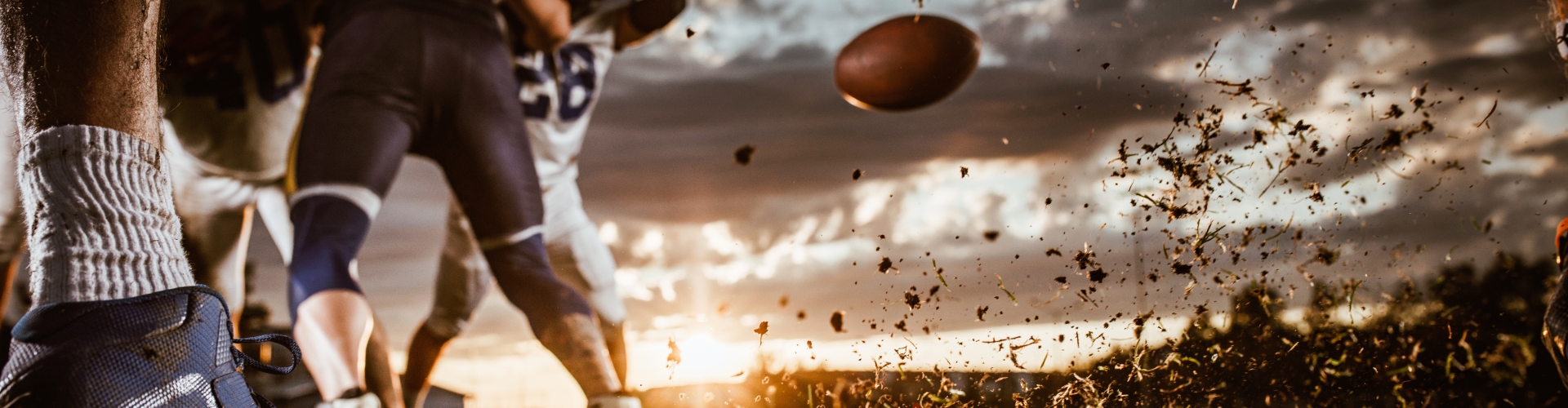 football player kicks football