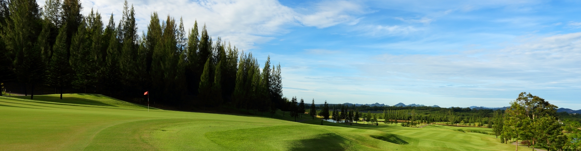 Image of golf course with blue sky.