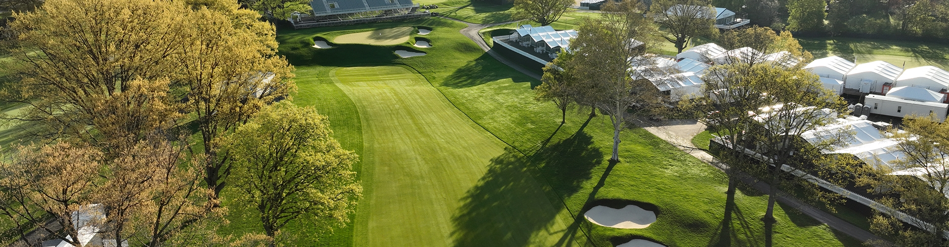 Aerial photo of a golf fairway with trees and sandtrap