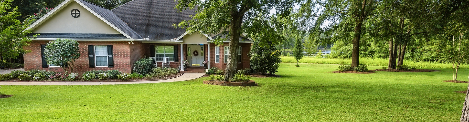 Brick house with grass and trees