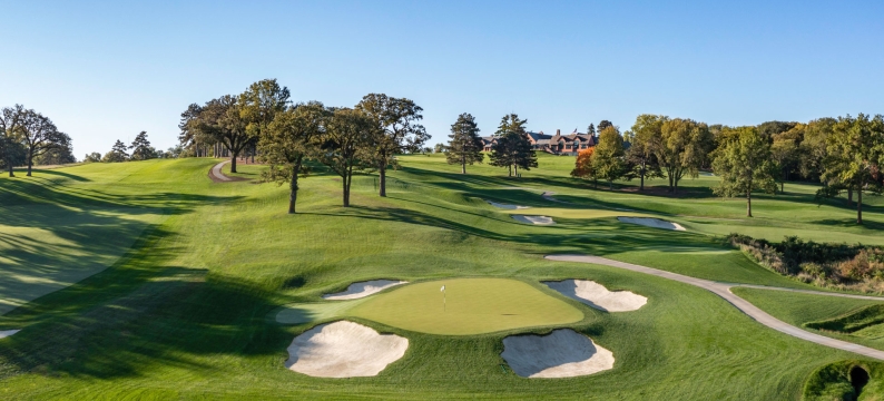 Ariel view of Omaha Country Club's green fairways with RTF bunker surrounds under blue skies.
