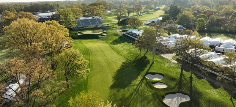 Aerial photo of a golf fairway with trees and sandtrap
