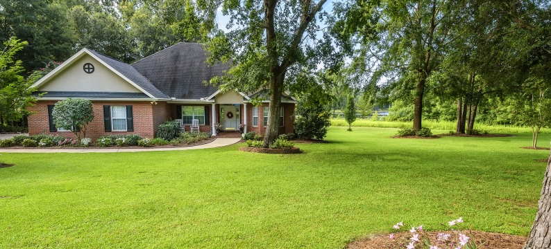 Brick house with grass and trees